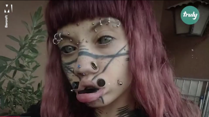 Screenshot_2020-03-12 Woman with extreme body mods has over 20 facial piercings(1)