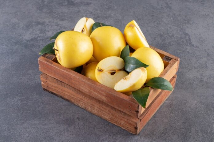 yellow apples in box