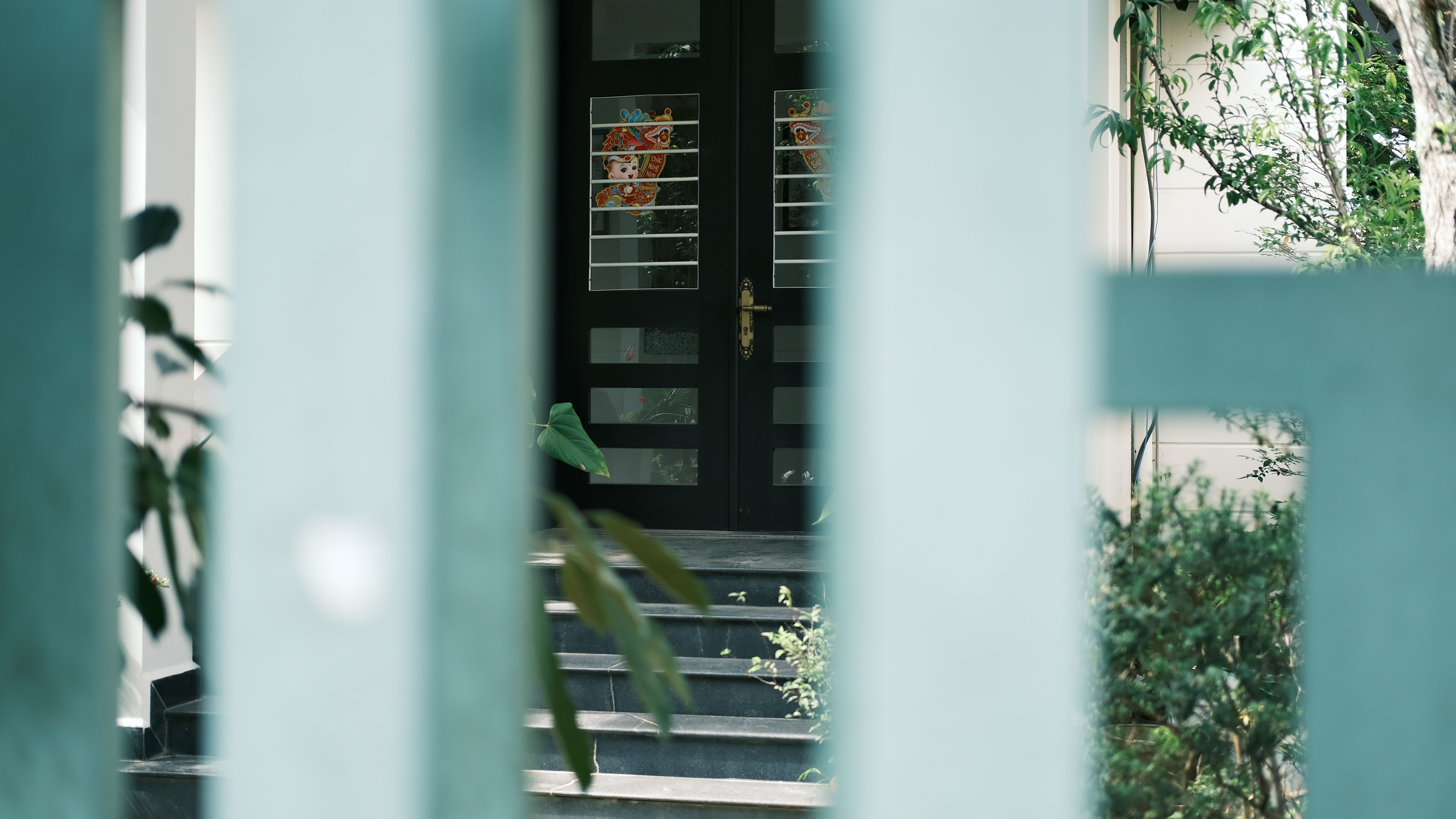 Sophisticated private gated entrance framed by lush greenery exuding mystery and discretion