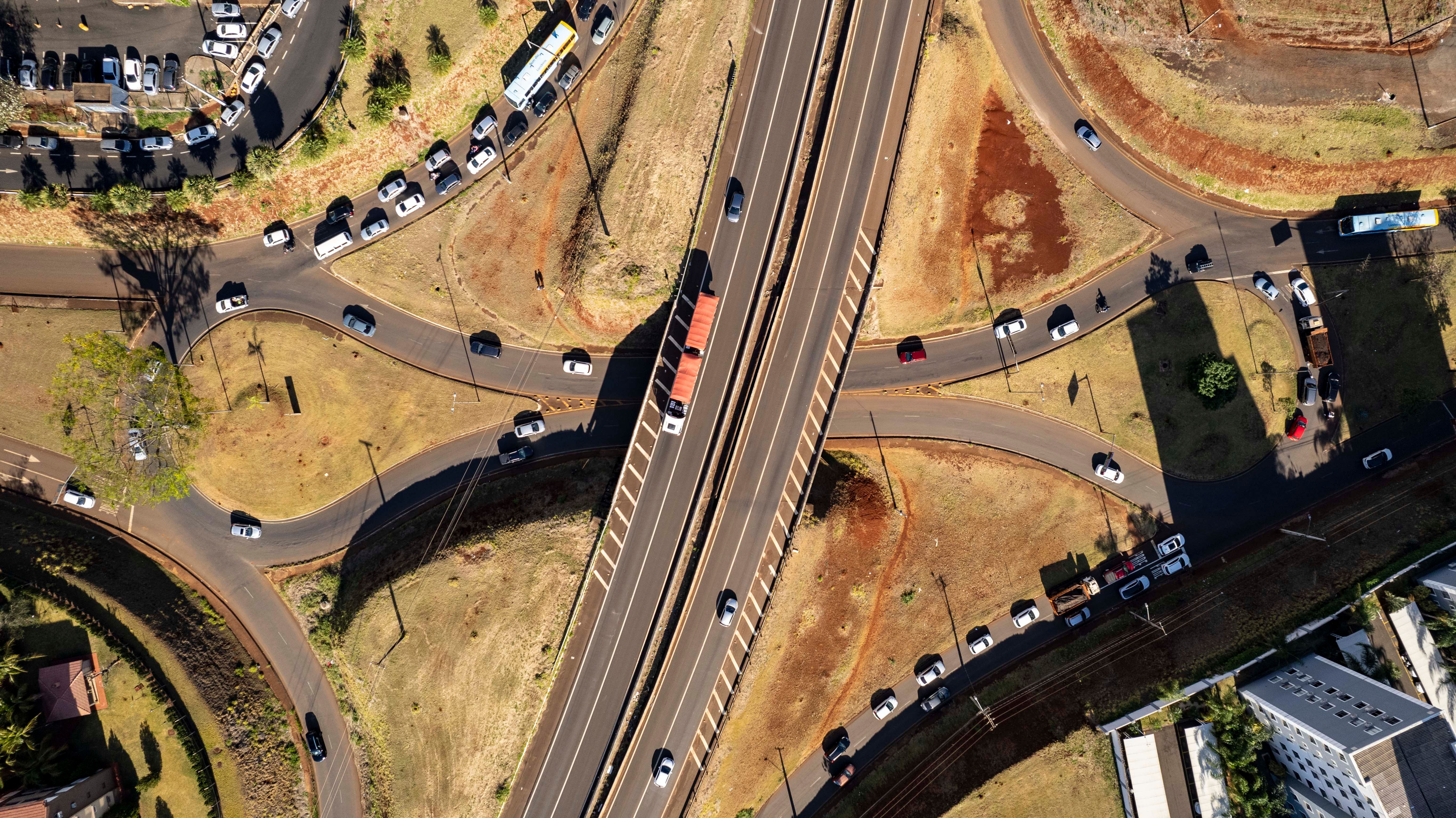 Aerial view of a busy highway interchange illustrating how airport roadway connections can route traffic.