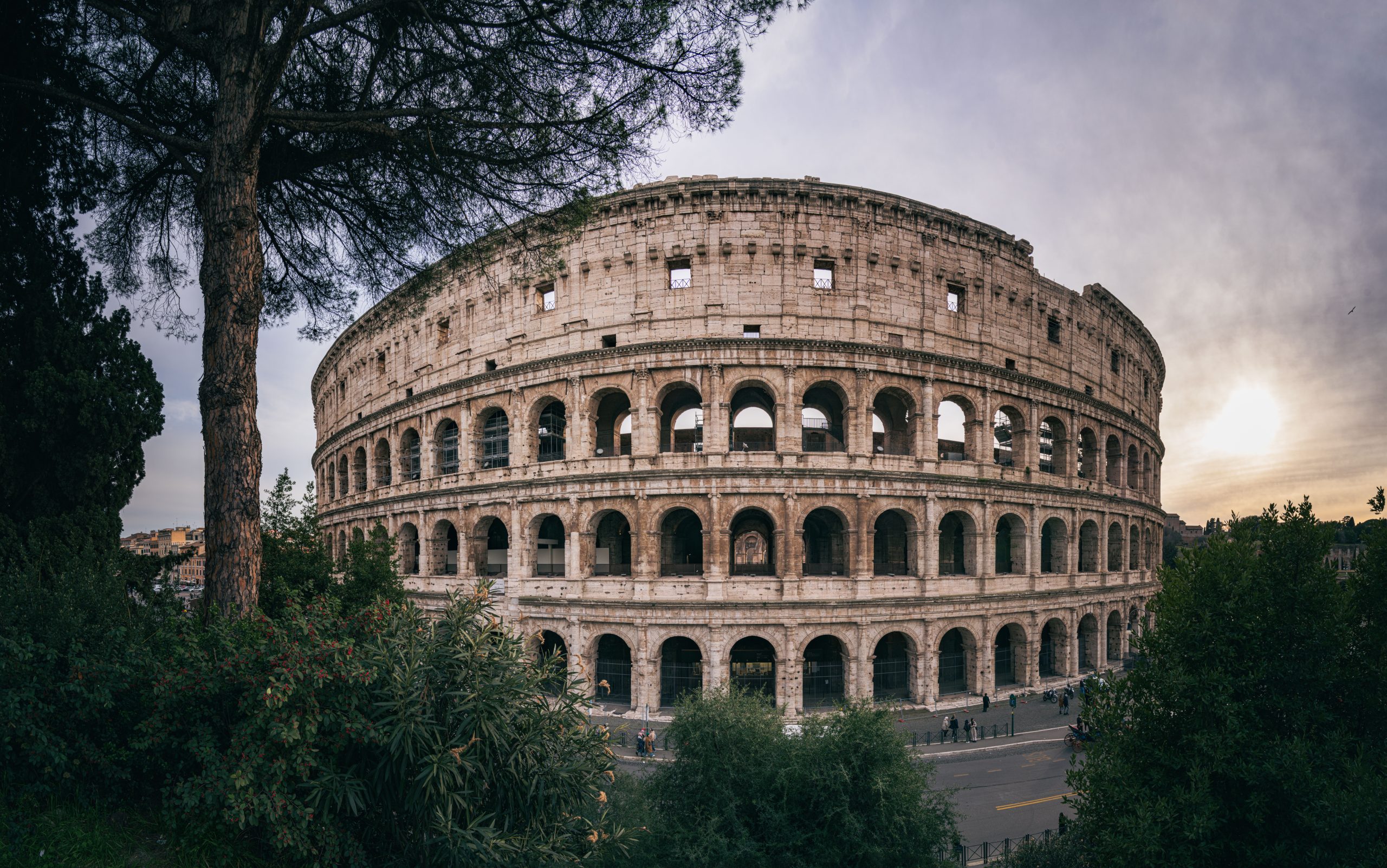 Wide view of the Colosseum in Rome at sunset, a defining historic destination for culture lovers