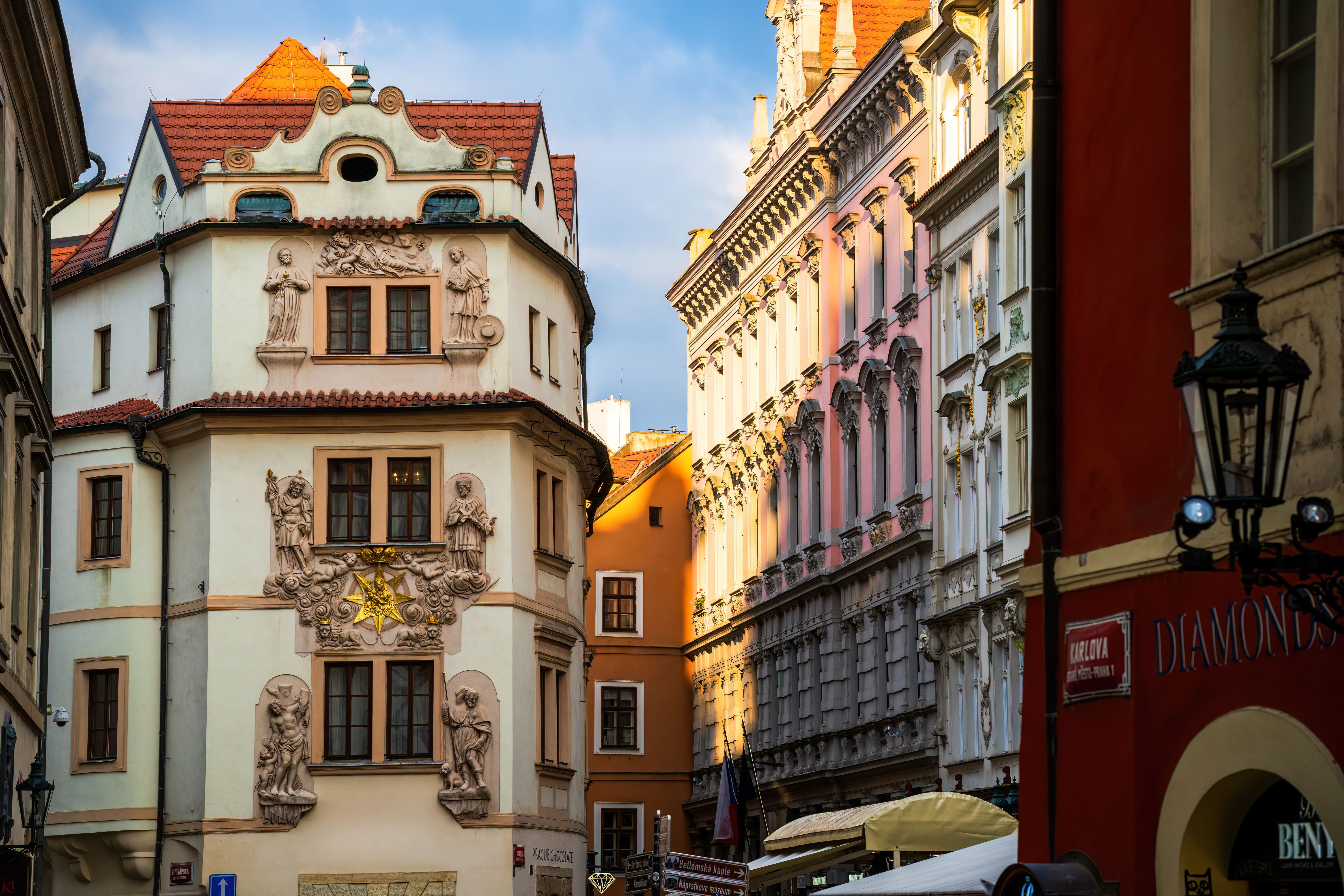 Ornate historic facades in Prague's old city center glowing in golden sunlight